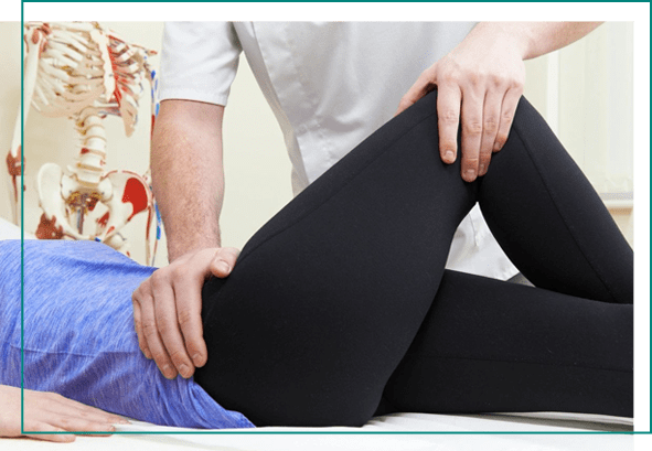 A person is stretching on the ground while another person holds their hands over them.