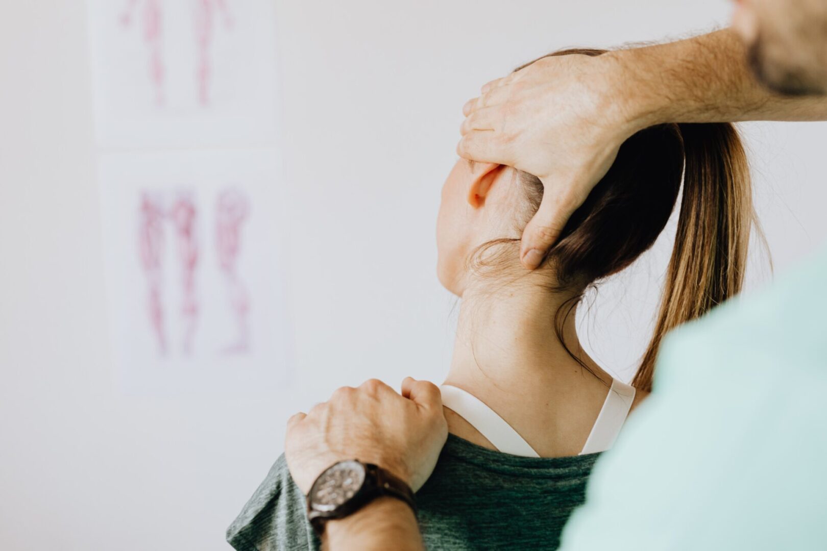 A woman is getting her neck examined by an osteopath.