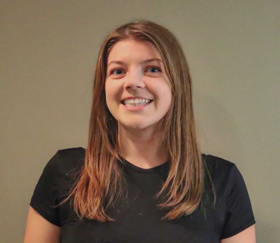 Smiling woman with long brown hair.
