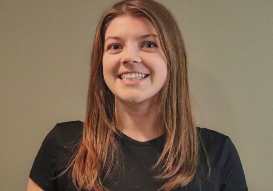 Smiling woman with long brown hair.