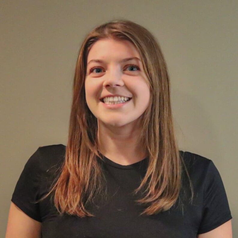 Smiling woman with long brown hair.