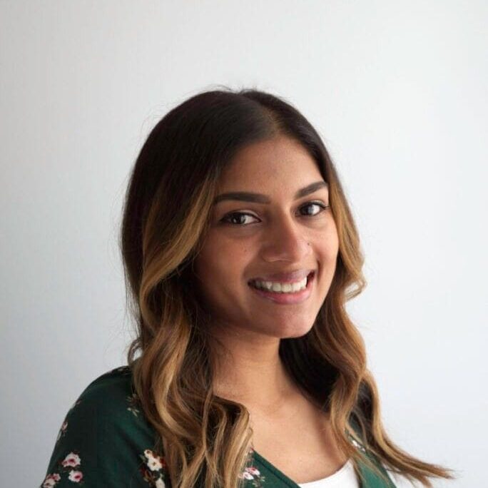 Smiling woman in floral dress.
