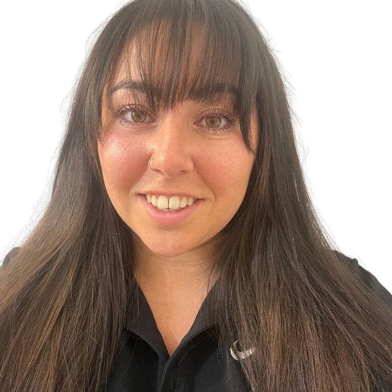 Here's a short alt tag for the image: Smiling woman with long brown hair.